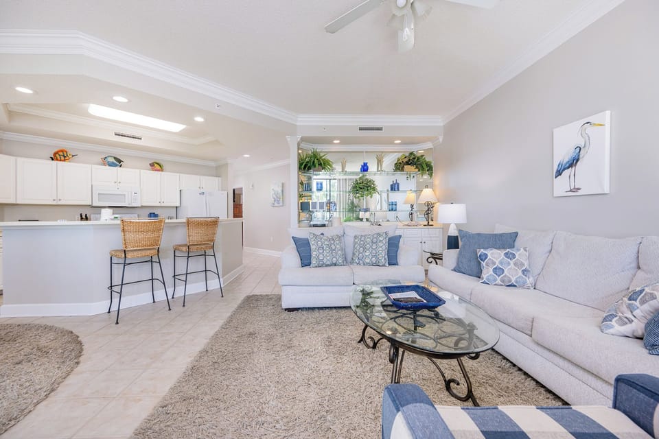 Unwind on the plush sofa, where coastal decor invites you to relax and enjoy shared moments with loved ones