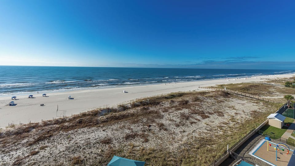 Breathe in the fresh air and enjoy the expansive views of the tranquil water and beach from your balcony