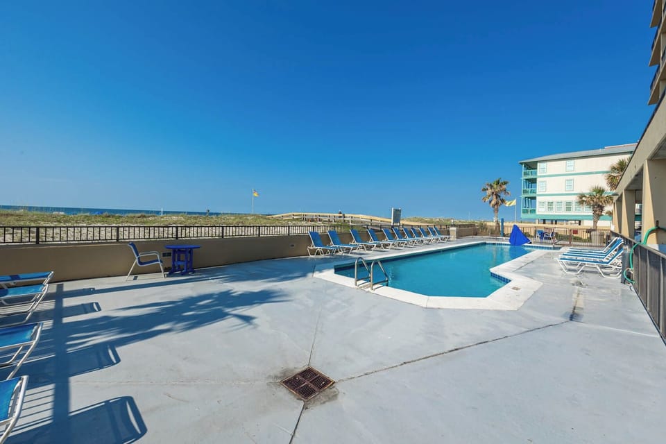 Relax by the pool with beach views and lounge chairs, perfect for unwinding after a day of fun in the sun