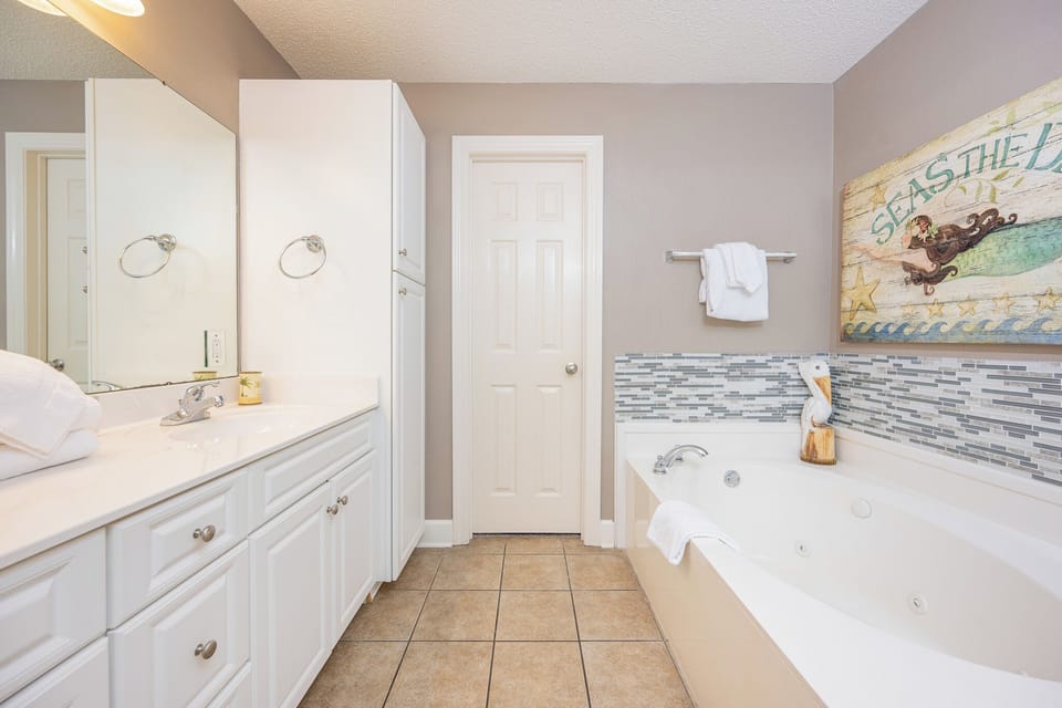 Indulge in relaxation in the master bath with a refreshing walk-in shower and soothing jetted tub