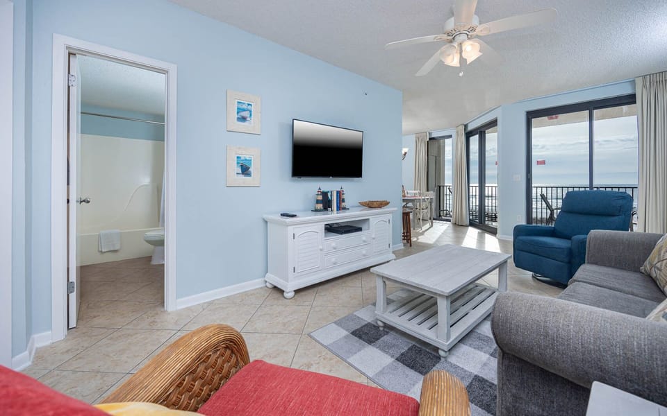 Relax in the inviting living area with comfortable seating, sofa with queen sleeper, and beachfront views