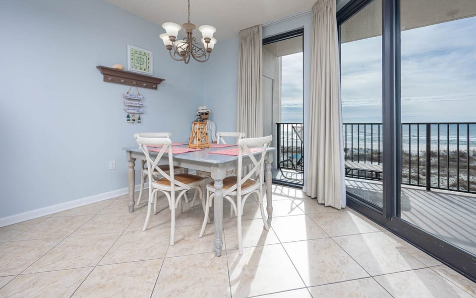 Gather around the charming dining table, with natural light streaming in and views of the coastline just outside