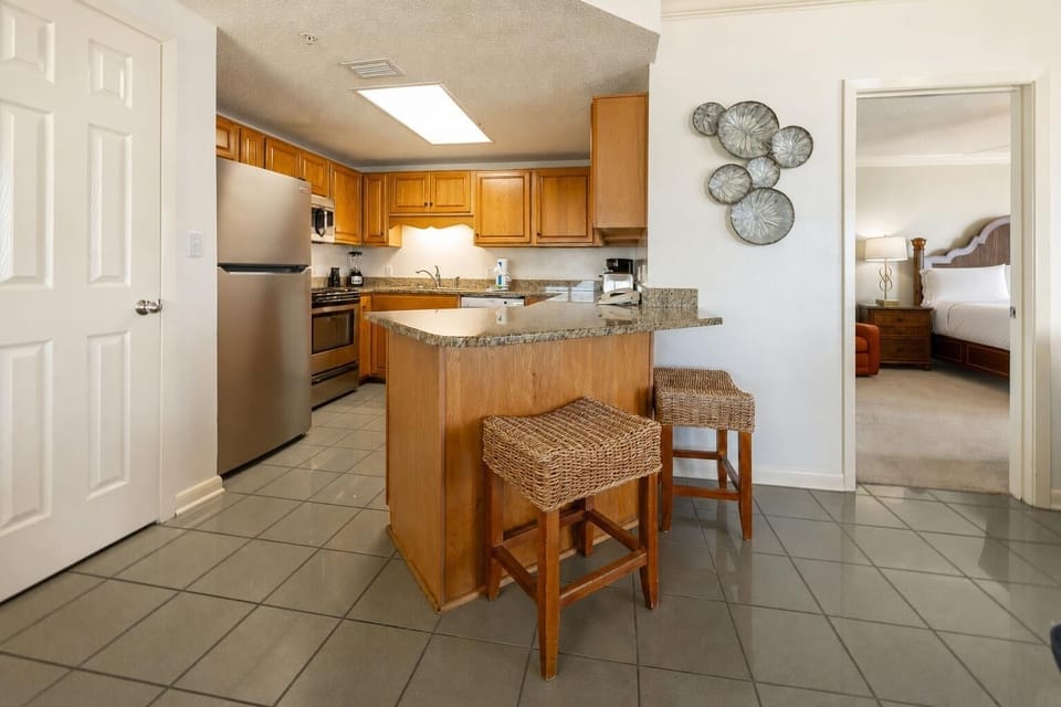 Two stools invite you to chat or snack at the kitchen breakfast bar while preparing meals with ease
