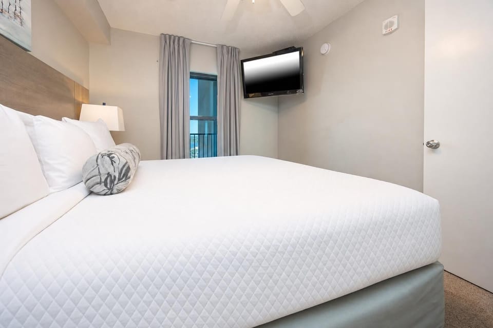 Rest in the comfortable bedroom featuring a plush king bed, soft lighting, and a TV for your entertainment