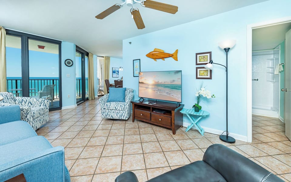 Relax on patterned chairs facing the TV as you listen to distant beach sounds from your living room