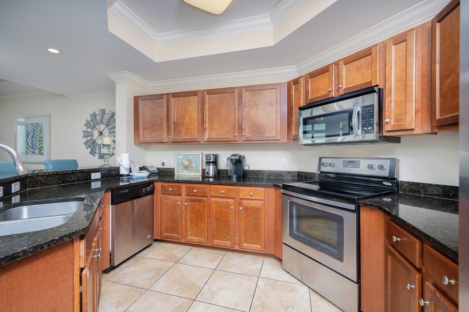 This kitchen features stainless appliances, granite countertops, and a Keurig coffee maker for a delightful morning brew