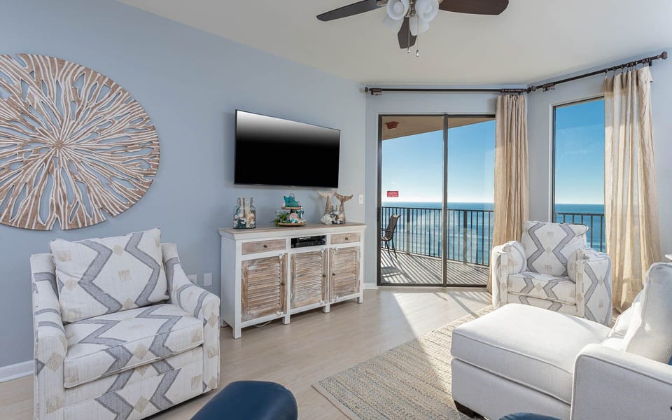 Relax in the inviting living area featuring a sofa with queen sleeper and a beach view that opens to the balcony