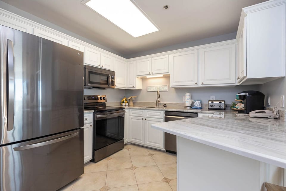 Prepare delicious meals in this elegant kitchen featuring stainless appliances and elegant marbled countertops