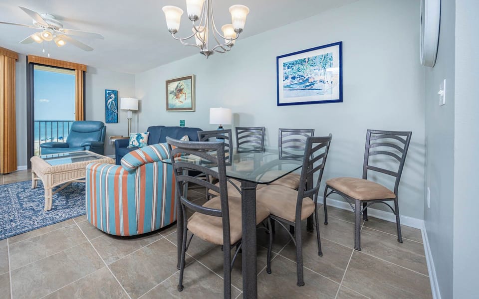 Gather around the glass dining table, enjoying beachfront views from the dining and living area