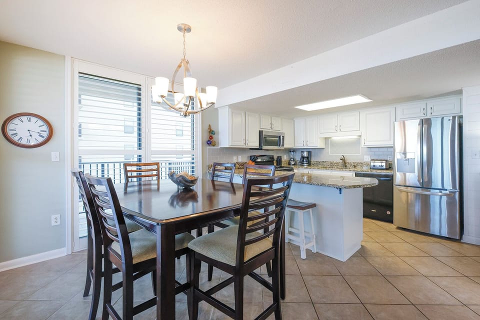 Gather around the dining table for meals with a beachfront view