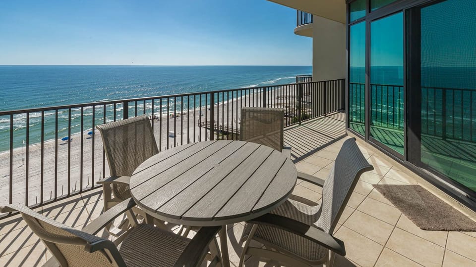 Unwind on your balcony, taking in stunning coastal views while sipping a refreshing drink