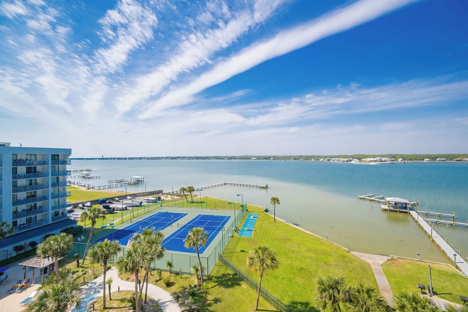 Breathe in the coastal breeze as you unwind on your balcony, enjoying views of the lagoon and vibrant tennis courts