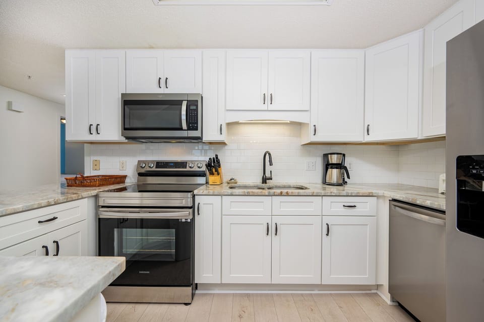 Cook and gather in this sleek kitchen featuring stainless steel appliances and ample counter space for meal prep
