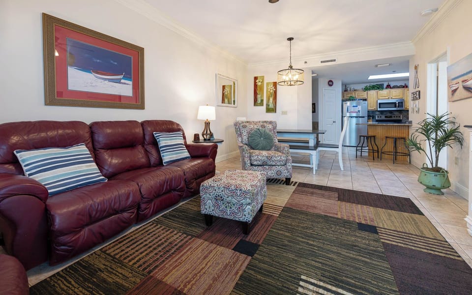 Relax in the inviting living area with plush seating, colorful decor, and easy access to the dining space