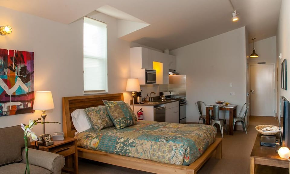 Reclaimed teak queen bed with handmade quilt in aqua tones.