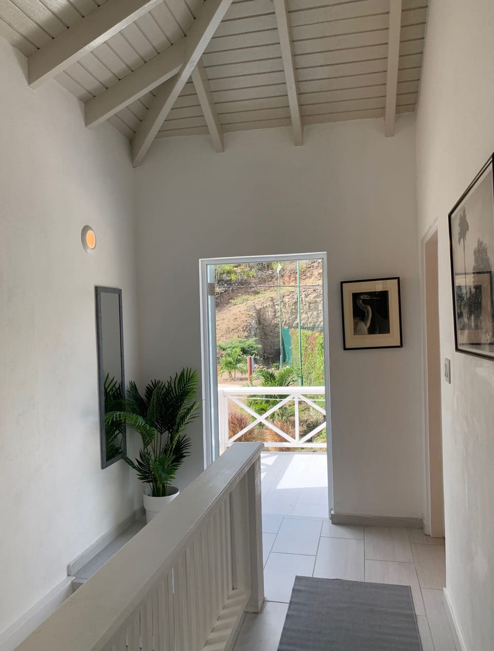 Upstairs landing with louvred door leads on to elevated patio 