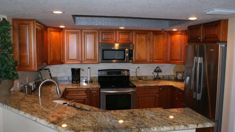 Beautiful kitchen fully stocked, with all wood cabinets and granite counter top.