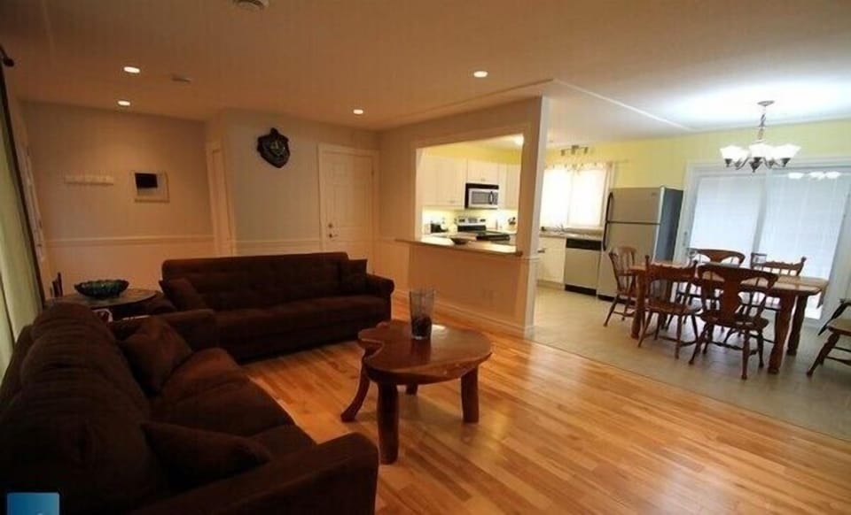 Upper unit living room with view of open concept kitchen