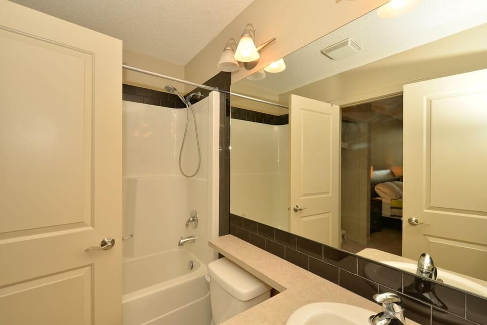 Bathroom has full shower and bathtub, and enters to the master bedroom