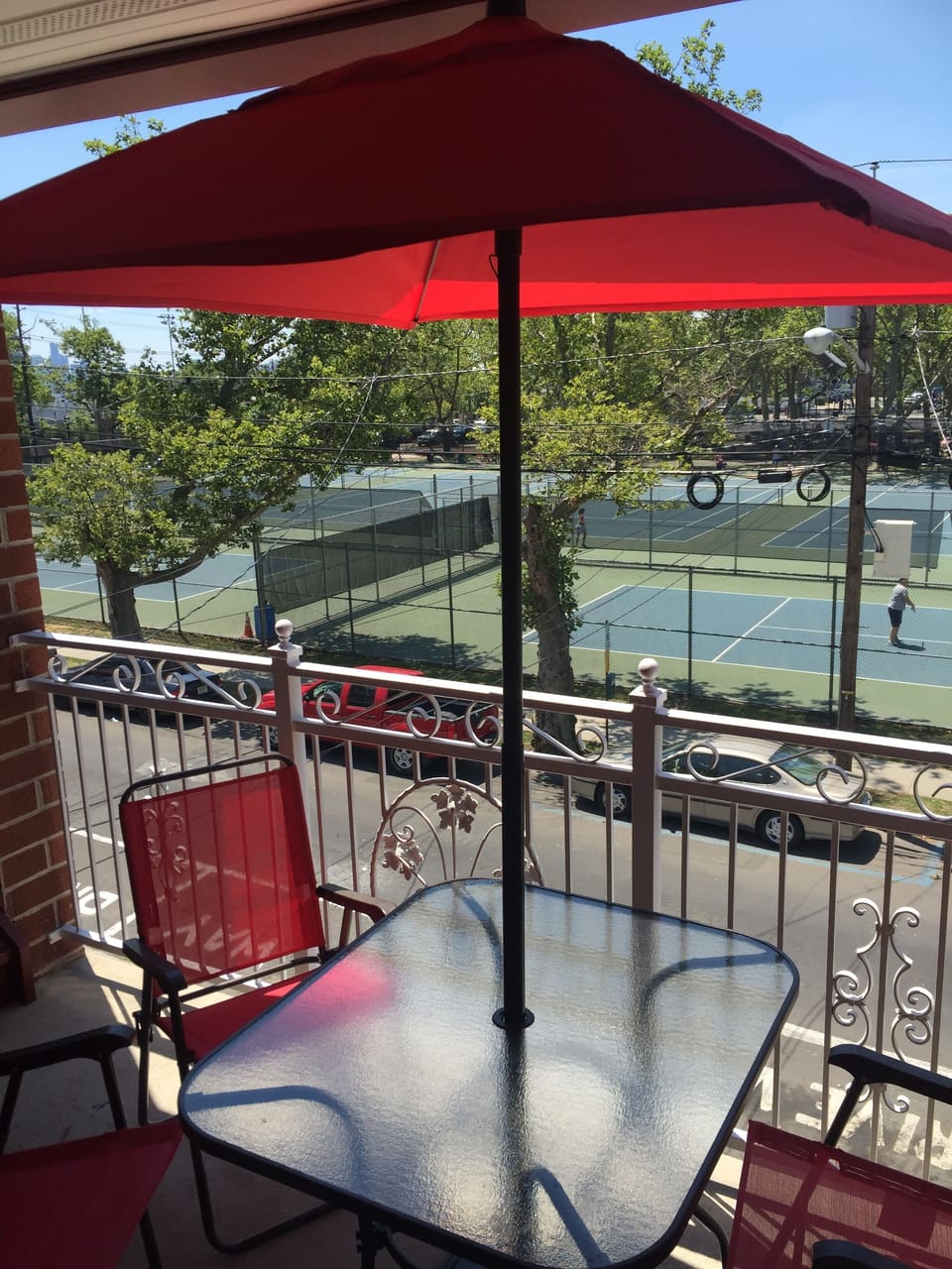 Front deck complete with table, chairs, and umbrella for your enjoyment.
