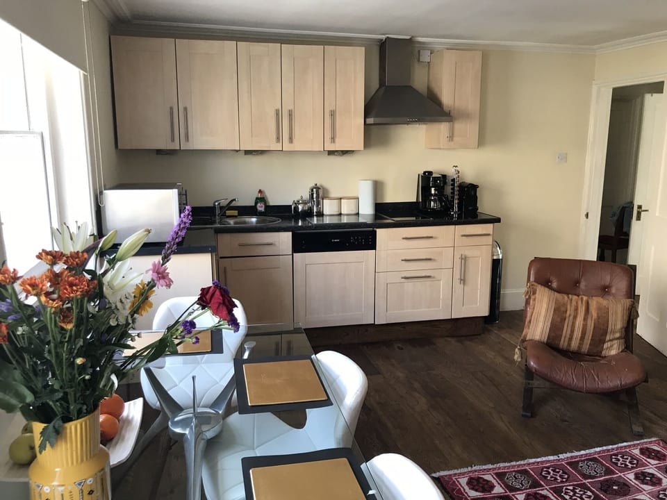 kitchen with nespresso machine, dishwasher, fridge, microwave, etc