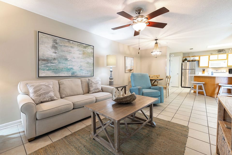 Unwind in the cozy living area, featuring a comfortable sofa, stylish decor, and a charming dining space