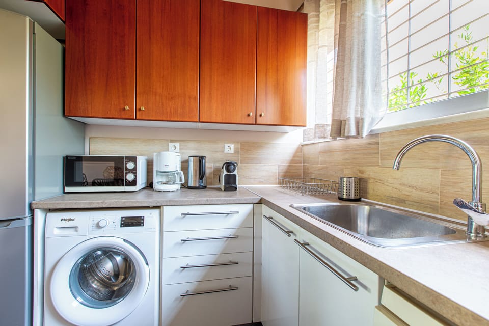 Fully equipped kitchen with dishwasher and washing machine for added convenience. (1)