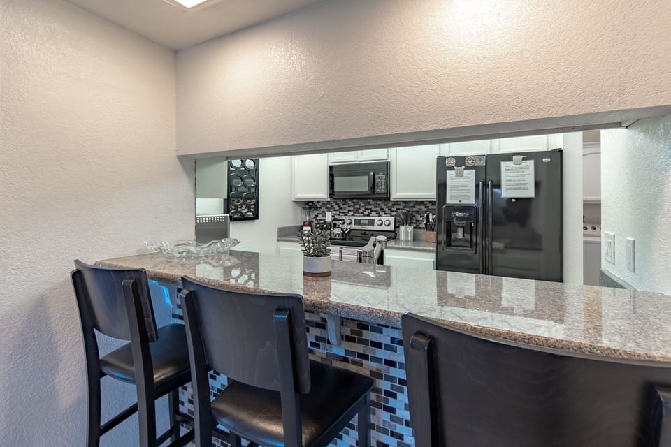 3 seat bar between kitchen and dining area perfect for laptops and doing work!