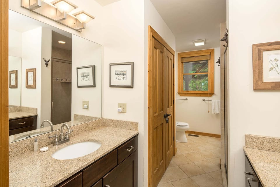 Spacious master bathroom with a double vanity and access to the walk-in shower