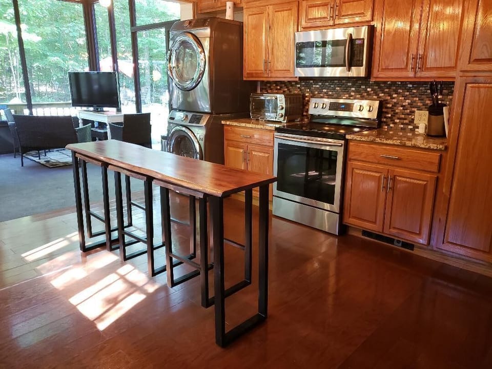 Modern Appliances Kitchen leads into Glass Solarium SunRoom Dining Table and Bar