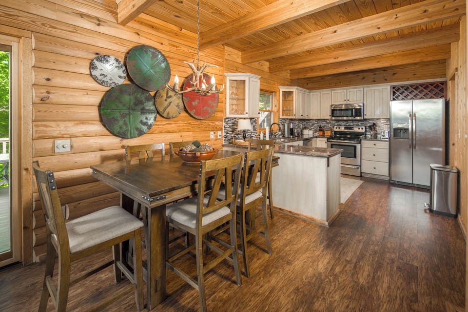 Dining area with seating for six beside the fully equipped kitchen