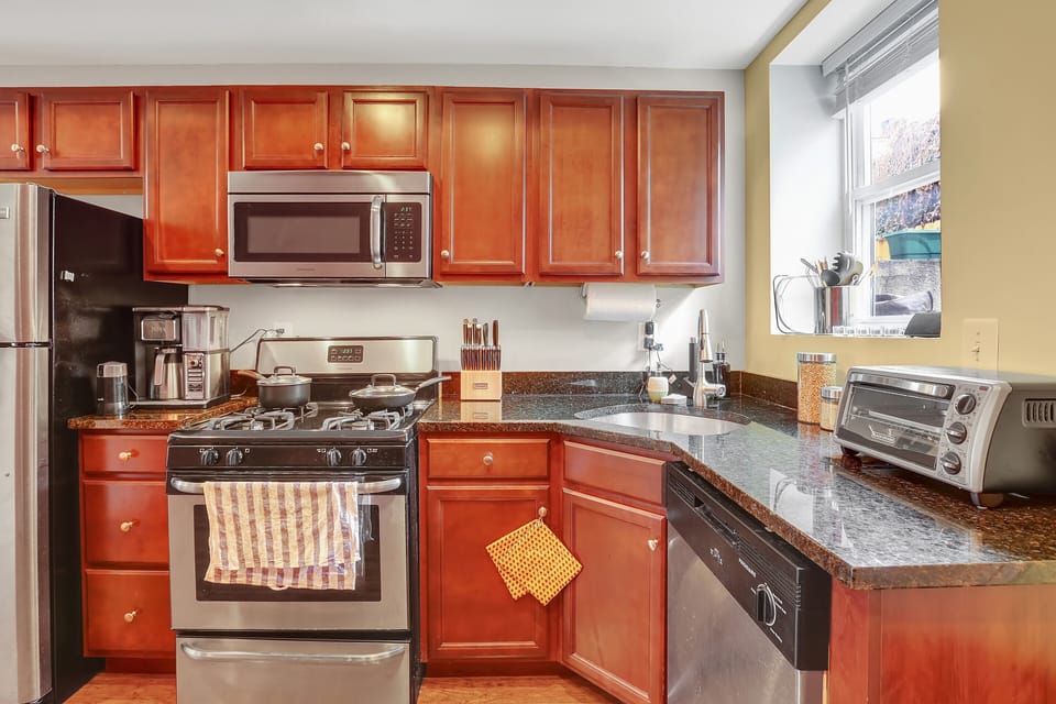 The kitchen is fully equipped and includes a gourmet coffeemaker. 