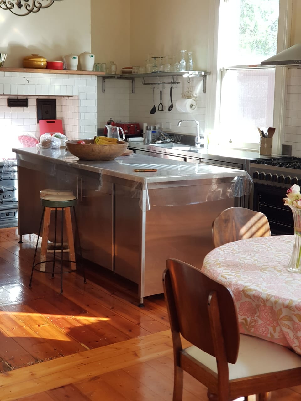 The kitchen is fully equipped with a large central bench.