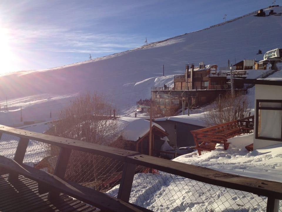 View to the Ski School, equipment rentals, restaurants and ski lift.