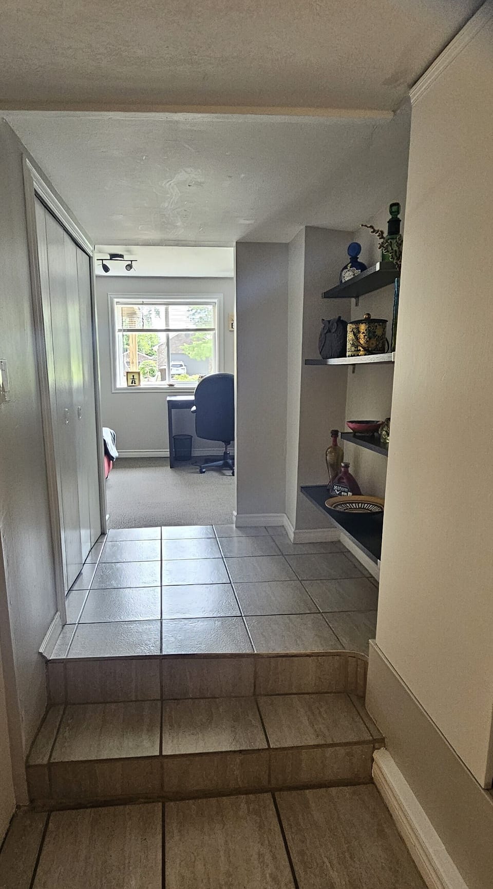 Hall from den to kitchen with laundry closet on the left