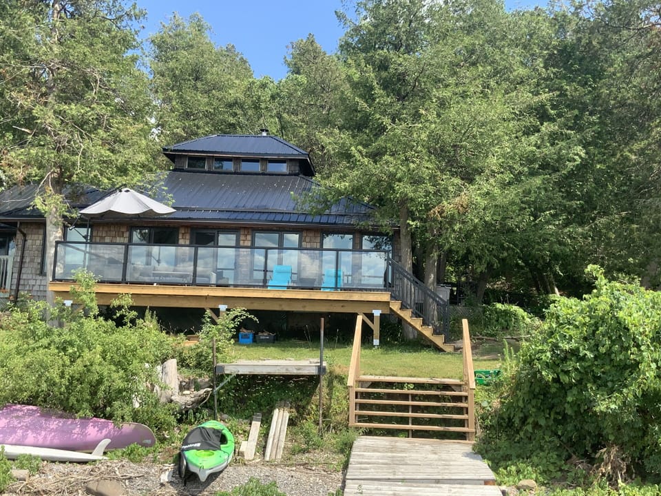 View of house from the dock. House is very close to the water.