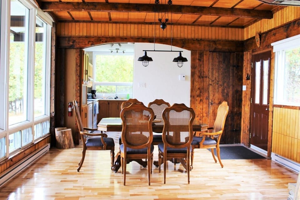 Floor to the ceiling Windows in the dinning room with a view of the lake and the mountains