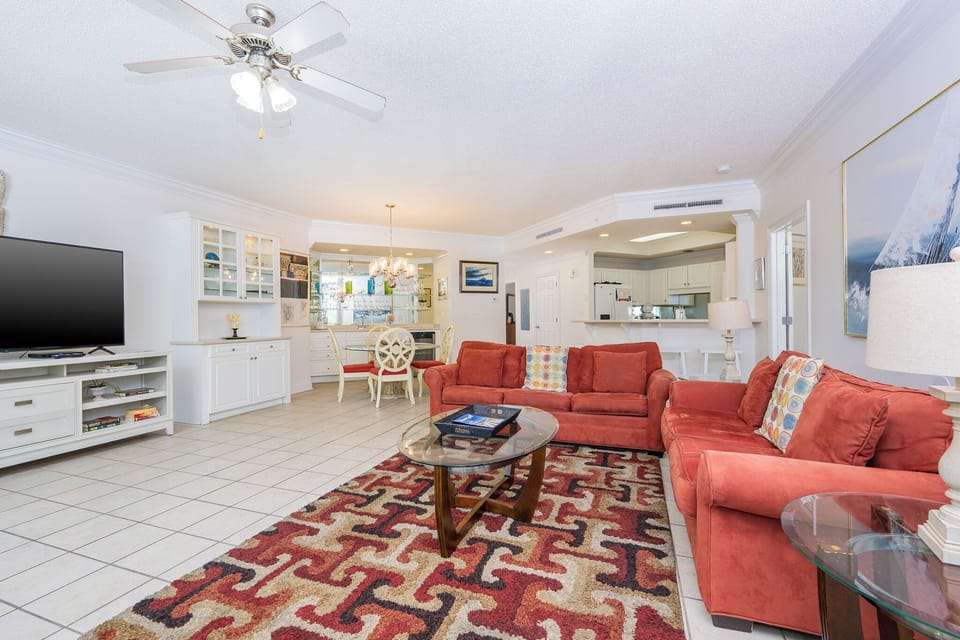 Gather in this welcoming living space and enjoy the coastal balcony views through the windows