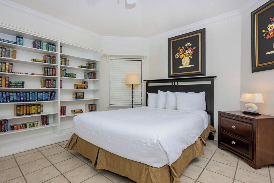 Curl up in the queen bed with your favorite book from the shelf in this serene guest suite, where comfort meets tranquility