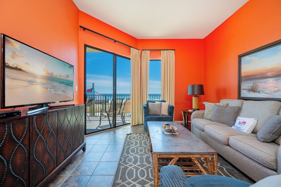 Soft couch cushions invite you to sink in while the gulf coast sparkles beyond the sliding doors
