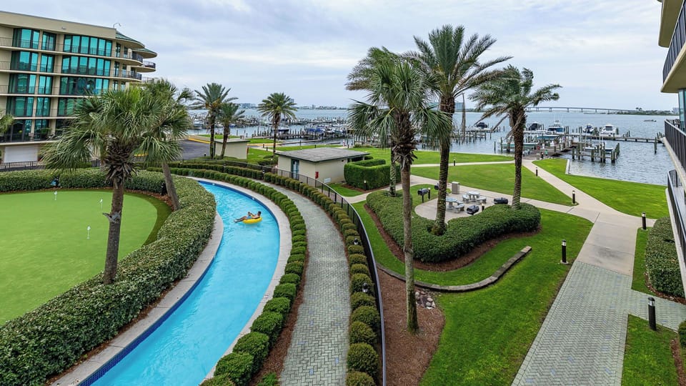 Palm trees sway over the lazy river where you relax on a float while watching sunlight dance on the water