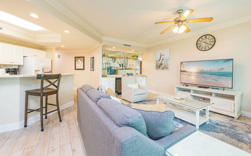 A soft chair and plush sofa invite you to relax while watching your favorite shows in the living room