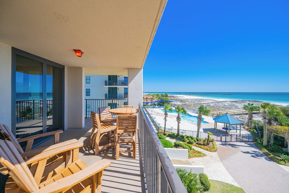 Sip your coffee while enjoying the coastal vibe from your balcony, overlooking the inviting pool and lush landscape