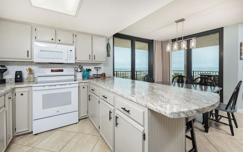 Brew your favorite coffee and enjoy the inviting vibe from your kitchen while gazing at the stunning coastal view
