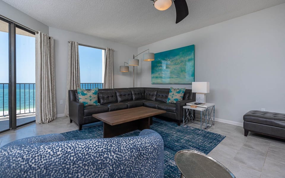 Relax on the spacious couch while enjoying the calming beachfront views from the balcony