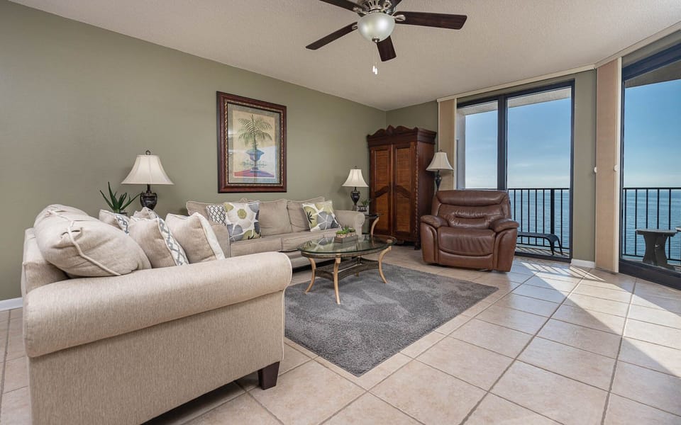 Unwind in the inviting living area featuring plush seating, sofa with queen sleeper, and stunning beach views