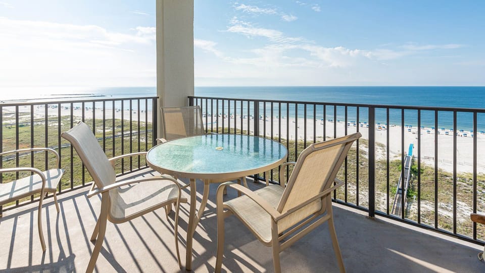 Balcony seating overlooks the beach and gulf, providing a serene spot to relax and enjoy the coastal view
