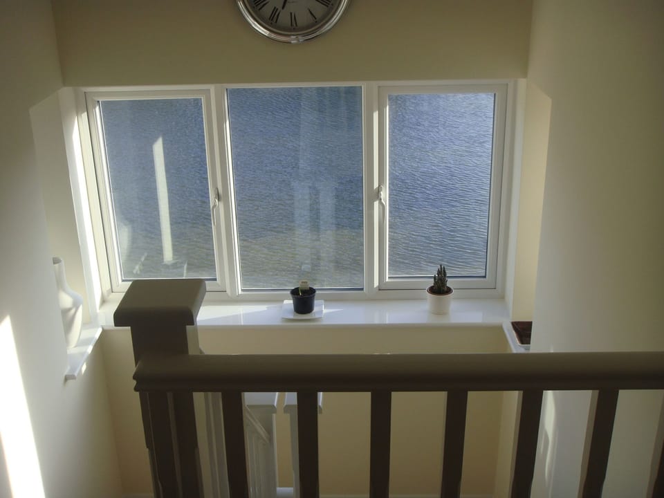 Gallery window looking out over lake from bedroom floors