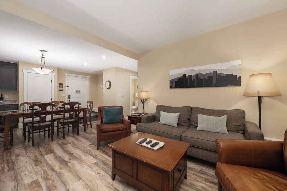 Open concept kitchen, dining and living area with gas fireplace, flat screen TV, pull-out sofa and views of the slope