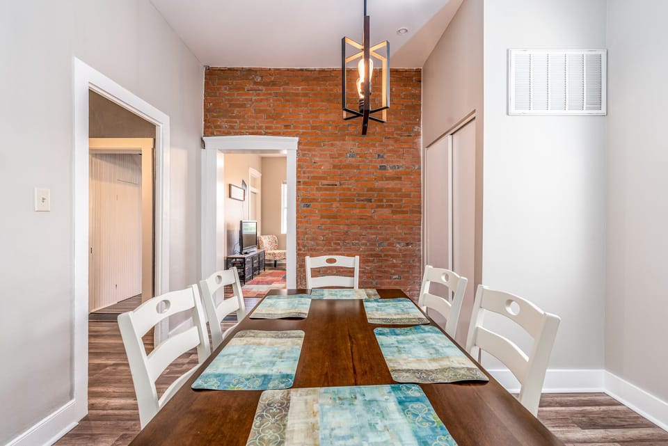 Dining area has historic feel with the original brick wall still intact.